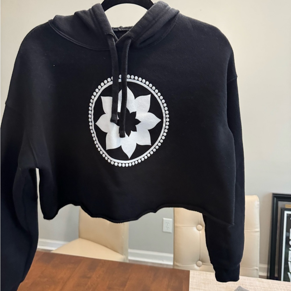 Black Cropped Hoodie with White Floral Design. Club Pilates